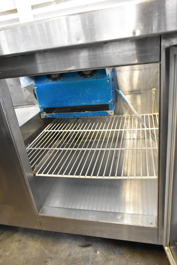 Universal Coolers stainless steel commercial prep table on casters. Features wire shelves and blue cooling unit. 115V, 1 phase.