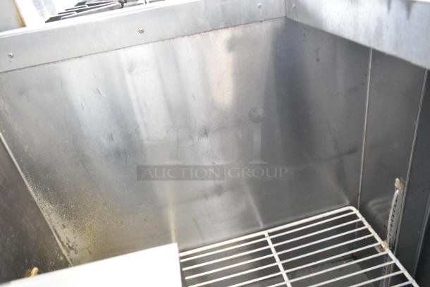Universal Coolers stainless steel commercial prep table with casters. Features durable metal construction, 115V, 1 phase.