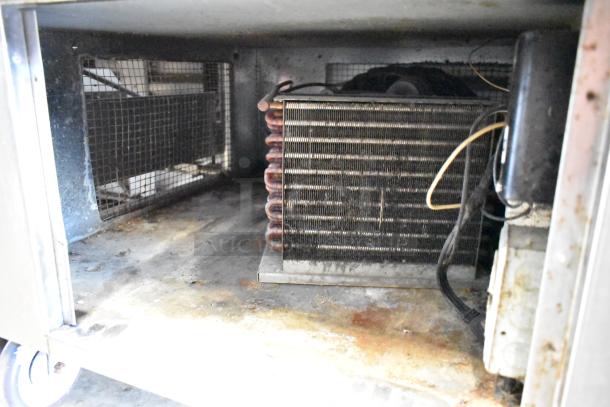 Universal Coolers stainless steel commercial prep table on casters, showing interior cooling unit and wiring, 115V, 1 phase.