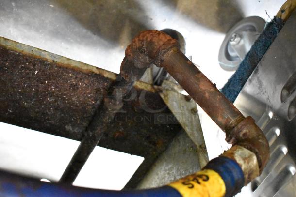 Rusty section of an Entree F3-N stainless steel commercial natural gas deep fat fryer. Visible wear on metal piping.