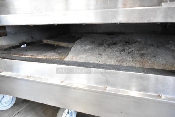 2021 Bakers Pride EP-2-2828 stainless steel pizza oven; 2 decks, broken stones visible; 208V, 1 phase.