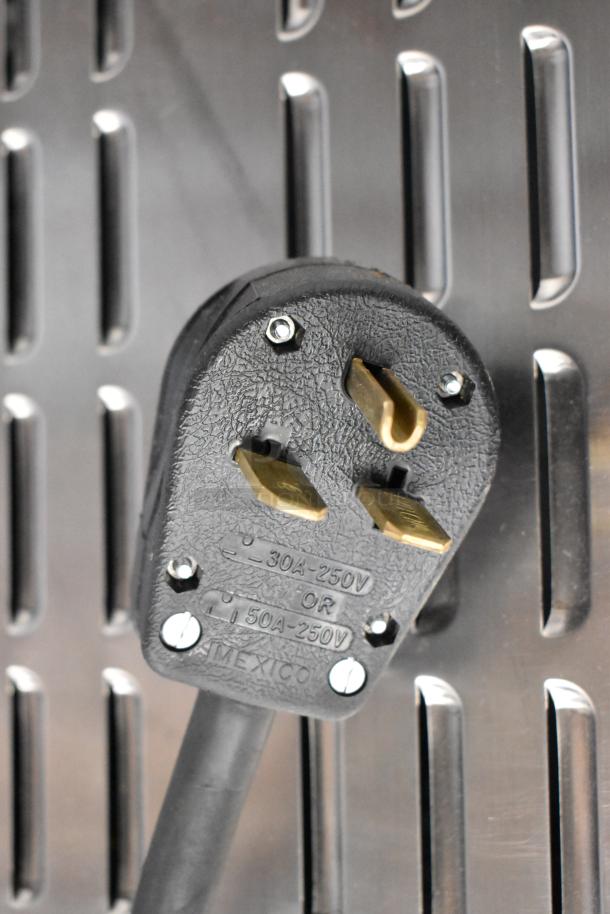 Close-up of the power plug for a Fetco CBS-1221 coffee machine. Black cord, labeled 30A-250V or 50A-250V.