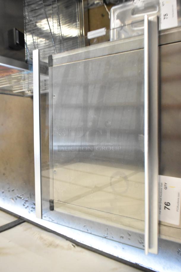 Brand new ServIt 423PDW12D1 stainless steel 12" pizza warmer, 4-shelf rotating rack, visible minor dents, 120V, 1 phase.