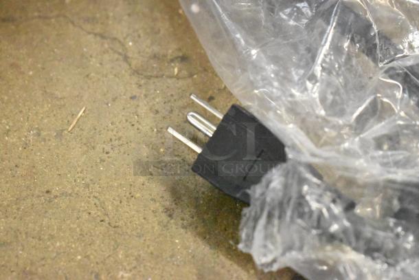 Power cord with plastic packaging for ServIt 423PDW18D2S Stainless Steel Display Warmer, 120V, 1 Phase, on concrete floor.