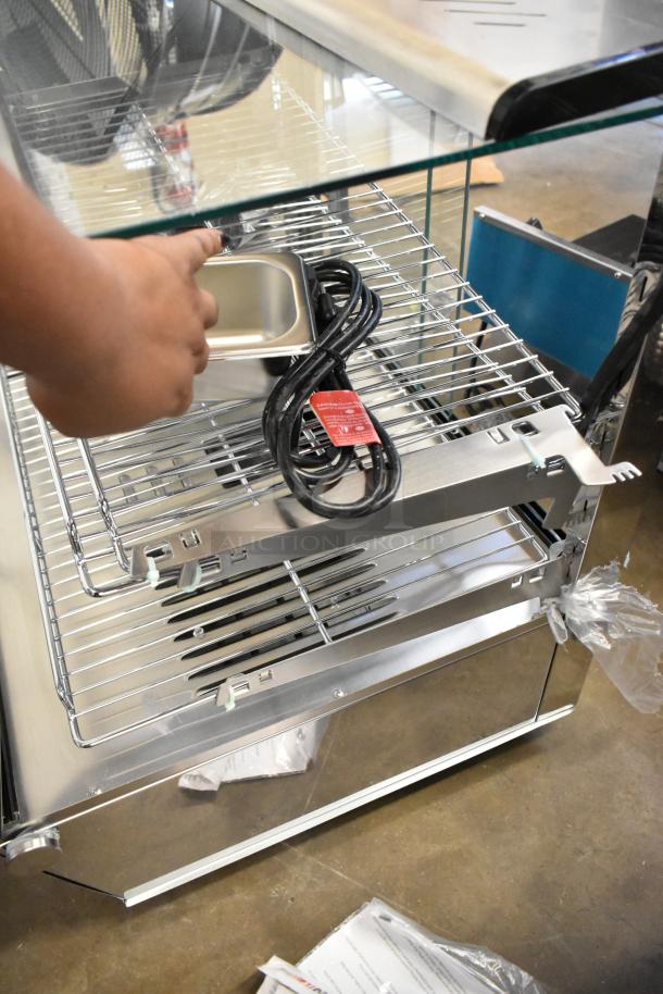 ServIt 423HDM26SA stainless steel heated display case with broken glass, missing rear doors, and visible power cord.
