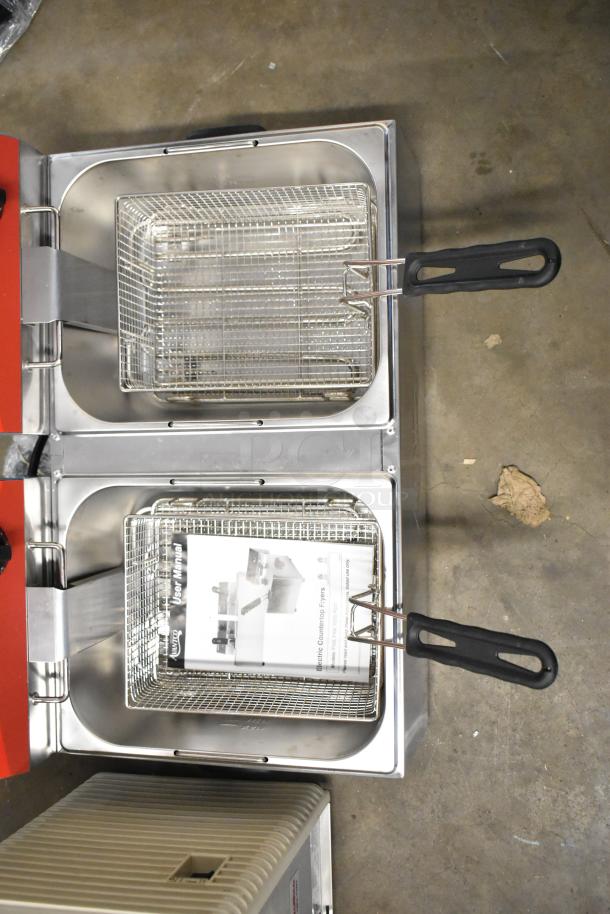 Brand new Avantco 177F102 stainless steel dual tank fryer with 2 baskets, 2 lids, 20 lb capacity, 120V, 1 phase; slight scratches.