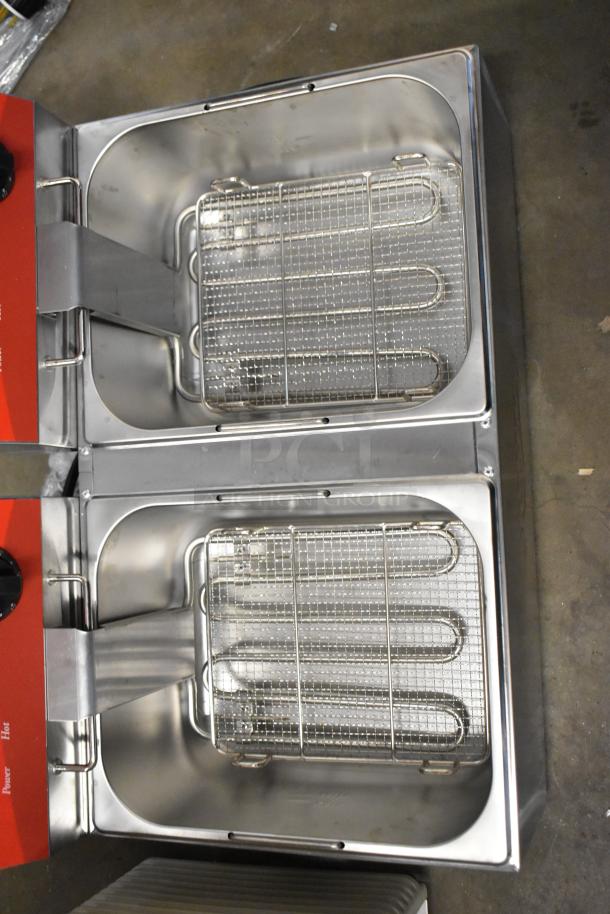 Brand new Avantco 177F102 stainless steel dual tank electric fryer, 20 lb. capacity, with 2 metal baskets and lids.