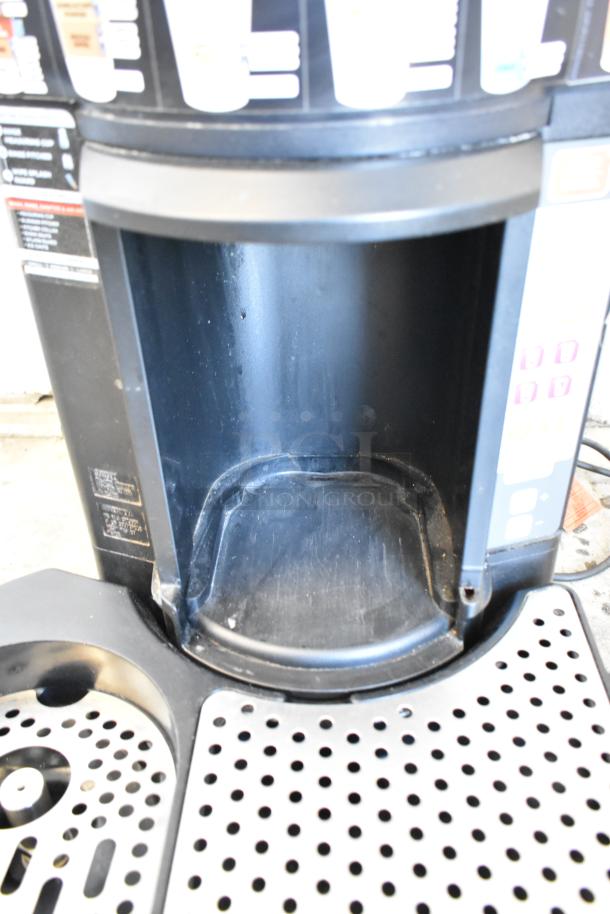 Taylor X83684-12 frozen beverage machine, black metal, commercial countertop. Control panel and drip tray visible.