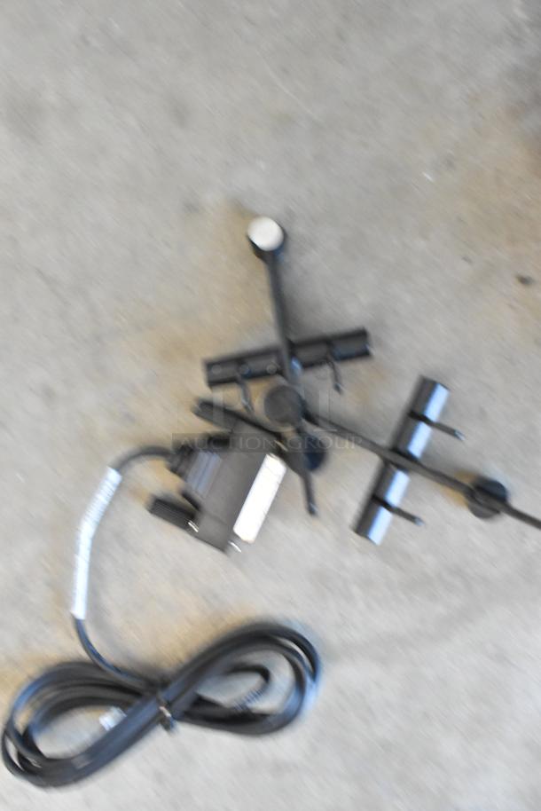 Taylor X83684-12 frozen beverage mixing machine parts scattered on concrete floor; includes black cords and metal brackets.