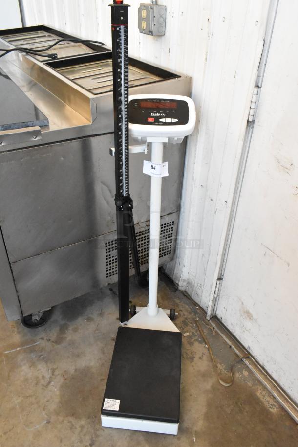 Galaxy 177MSD600 metal floor style scale with digital readout, height measurement rod, in good condition. Model 177MSD600 label visible.