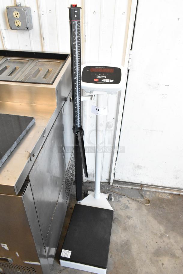 Galaxy 177MSD600 metal floor scale with digital display, height measurement rod, and sturdy platform. Excellent condition.