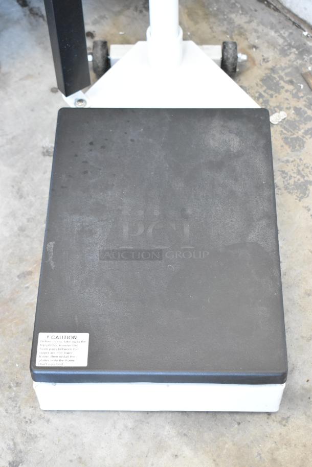 Galaxy 177MSD600 metal floor scale, black platform, white base, visible caution label, good condition, ideal for weighing tasks.