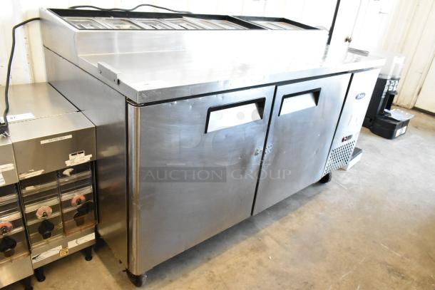 2018 Atosa MPF8202GR stainless steel pizza prep table with commercial casters, 115 volts, 1 phase, dual doors, good condition.