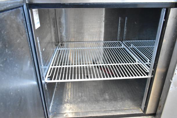 2018 Atosa MPF8202GR stainless steel pizza prep table interior, highlighting spacious, sturdy shelving and clean finish.