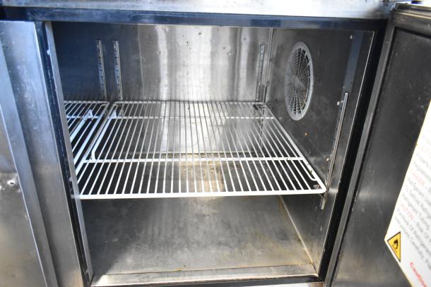 2018 Atosa MPF8202GR stainless steel pizza prep table interior with wire shelves and fan, in good condition.