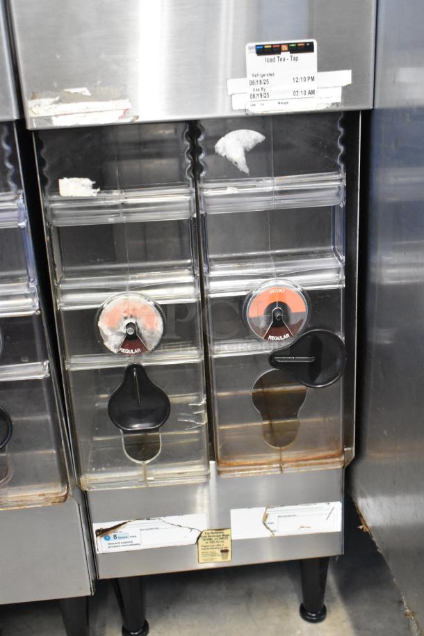Bunn ICDD-3 stainless steel reservoir stand, dual dispensers, visible wear, iced tea labels visible.