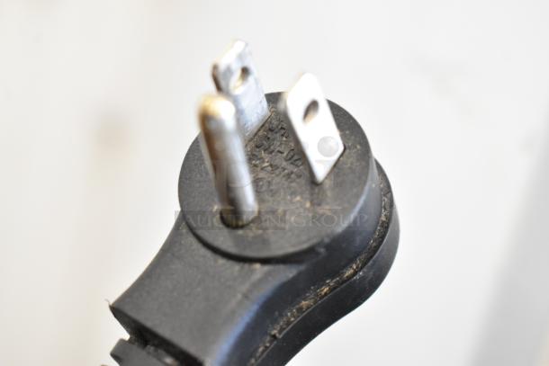 Close-up of a three-prong electrical plug for the Avantco 178GDC12FHCW cooler, showing slight wear.