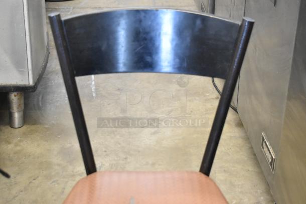 Dining height chair with a black metal backrest and tan seat cushion. Sold as a set of 7. Good condition.