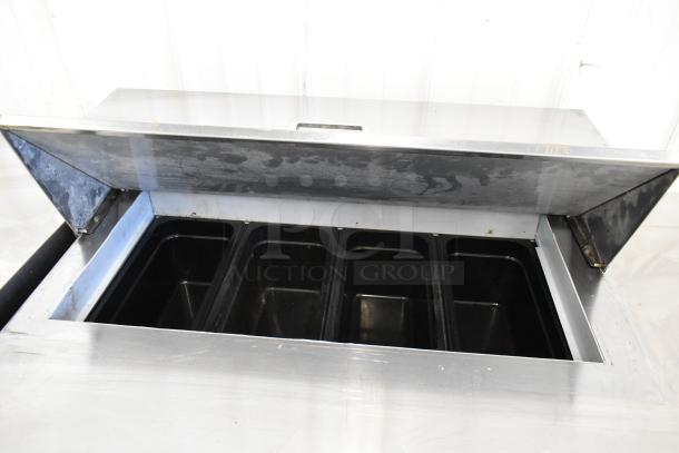 Beverage Air SPE48C stainless steel prep table with open top, showing food compartments. Commercial casters visible.