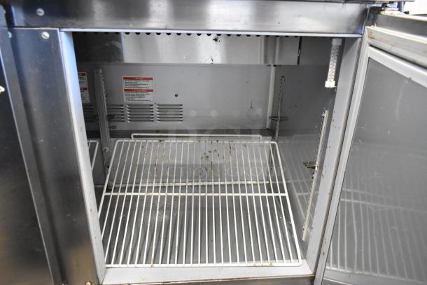 Beverage Air SPE48C stainless steel sandwich salad prep table, interior view showing wire rack and temperature gauge.