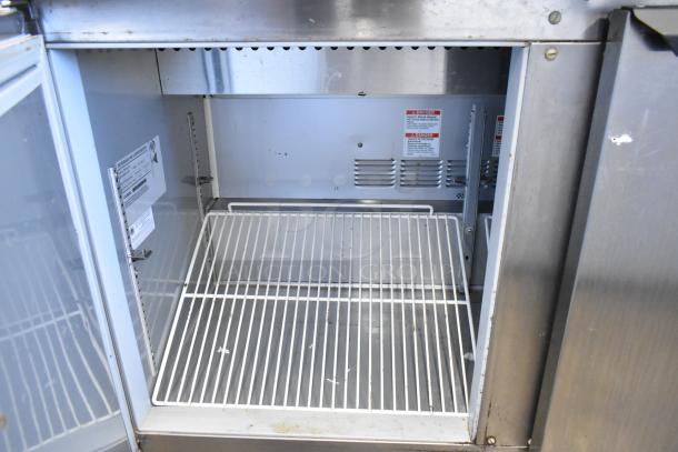 Beverage Air SPE48C stainless steel prep table, empty interior view, adjustable wire shelf, commercial casters visible.
