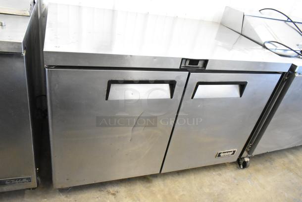 Bison MGF8402 stainless steel 2-door undercounter cooler, commercial casters, 115V, 1 phase, visible scuffs, and dents.