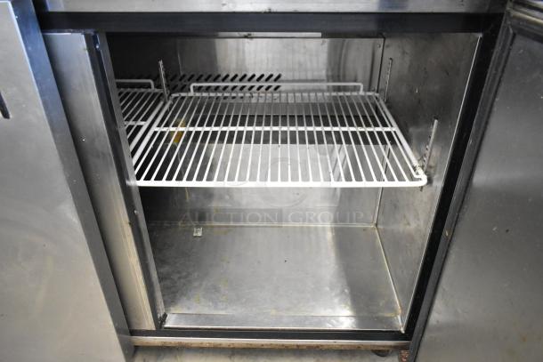 Bison MGF8402 stainless steel 2-door undercounter cooler, commercial casters, 115V, 1 phase, interior shelves, used condition.
