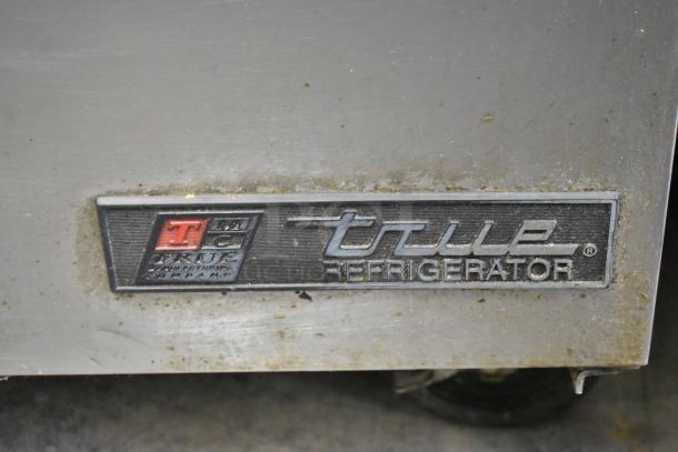 True TSSU-27-08 stainless steel commercial prep table, labeled "True Refrigeration," on casters, 115 volts, 1 phase.
