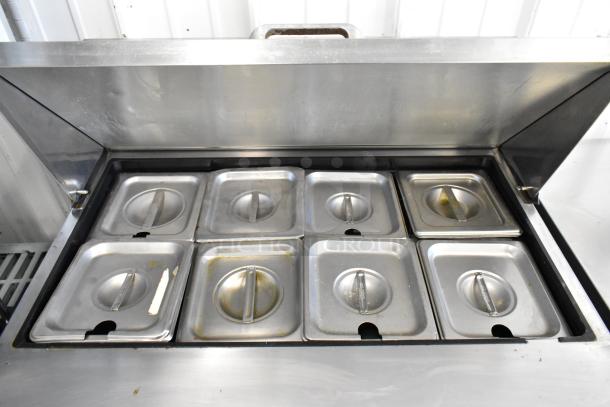 True TSSU-27-08 prep table with eight compartments, stainless steel, commercial casters, used condition, 115V, 1 phase.