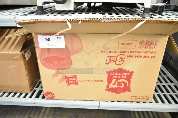 Box of 10 metal napkin dispensers, unopened, labeled "QTY X10." Auction lot 95.