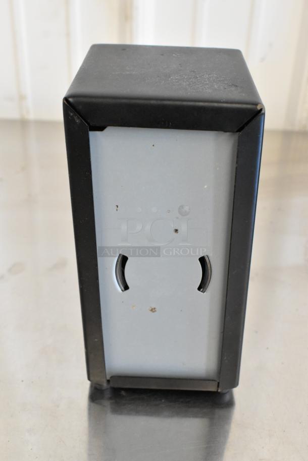 Metal napkin dispenser, rectangular design, black edges, visible wear, ideal for restaurants. Includes 10 dispensers per lot.