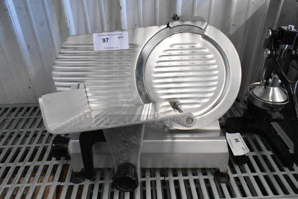 Omcan 300E stainless steel meat slicer with blade sharpener, commercial countertop model. 115 volts, 1 phase. Item shows minimal wear with visible auction tag.