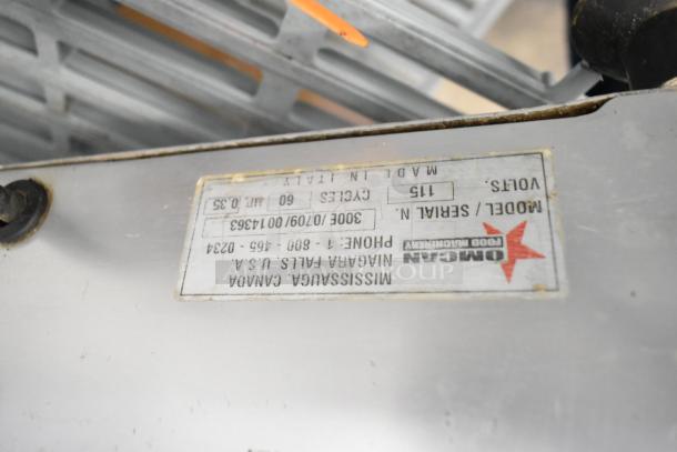 Omcan 300E stainless steel meat slicer showing a label with model number, 115 volts, made in Italy, used condition.