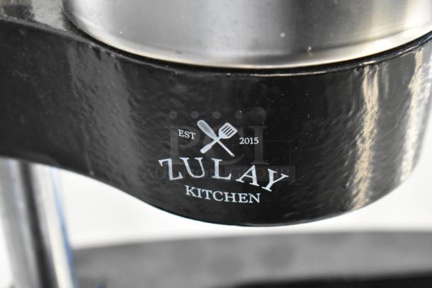 Zulay Kitchen metal manual citrus juicer, black finish, features logo and "Est. 2015," in good condition.