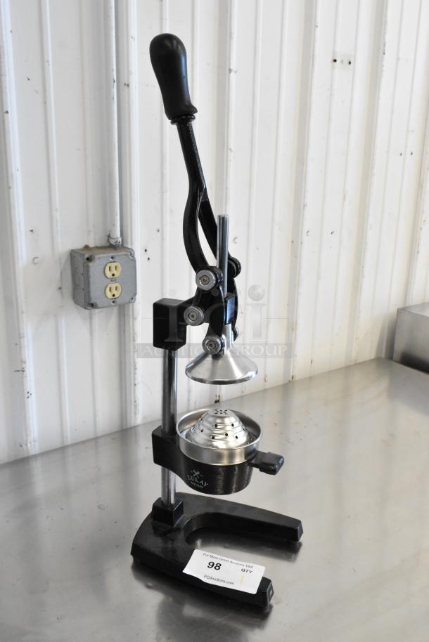 Metal manual citrus juicer with a black handle and sturdy base. Features include a cone press and strainer. Marked as Lot 98.