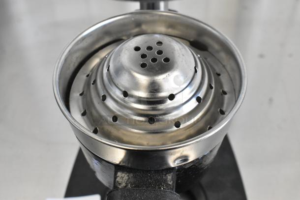 Metal manual citrus juicer with a strainer, sturdy design, and polished finish, in good used condition.