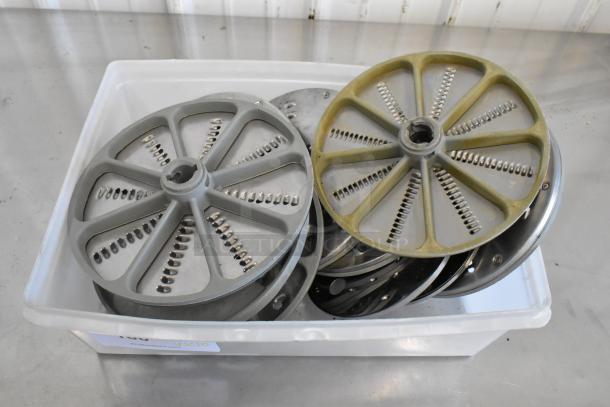 Set of 10 various food processor blades in plastic bin, used condition, suitable for different slicing and shredding tasks.