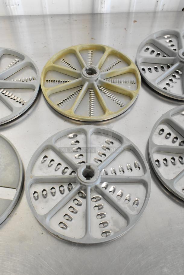 10 various food processor blades, circular shape, metal construction. Features shredding teeth. Used condition.