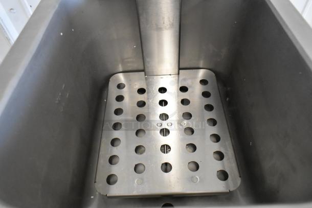 2024 Vollrath FFA8115 stainless steel fryer interior. Visible drip tray with perforations. Excellent condition.