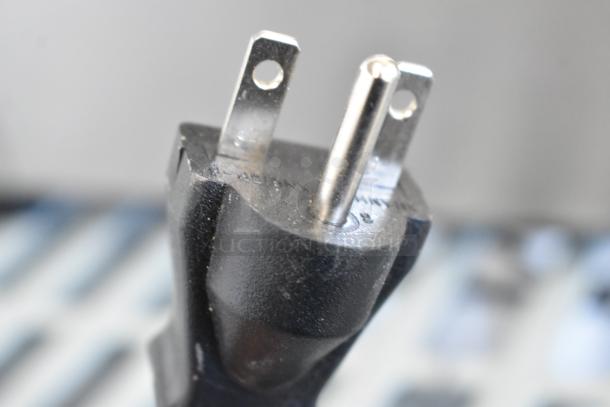 Close-up of a power plug for a 2024 Vollrath FFA8115 stainless steel countertop electric fryer, 208-240V, 1 phase.