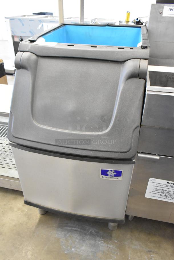 Manitowoc D320 stainless steel commercial ice bin with a large black lid, in good condition. Model label visible.