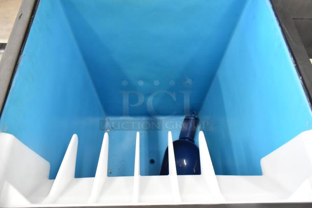 Manitowoc D320 stainless steel commercial ice bin interior. Blue liner, white dividers, clean condition.