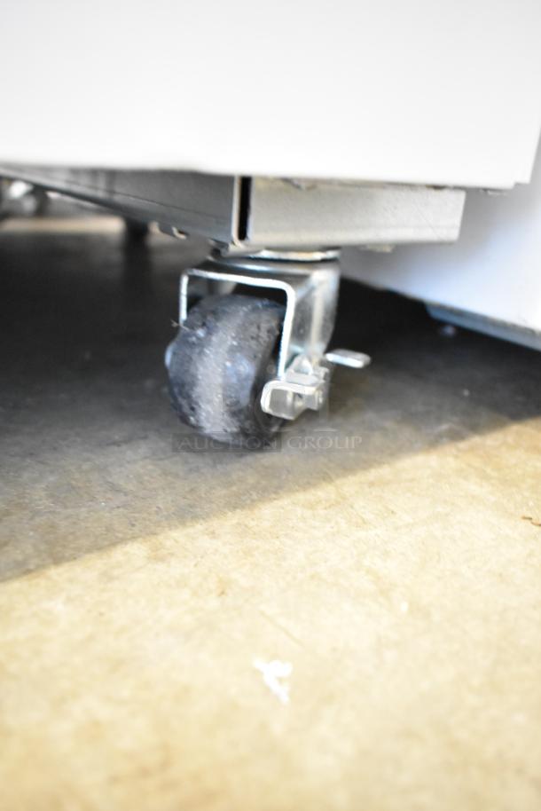 Close-up of a caster wheel on the 2024 Excellence EDC-8HC metal commercial chest freezer merchandiser.