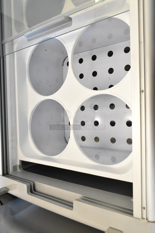 2024 Excellence EDC-8HC metal commercial chest freezer with perforated interior, commercial casters, and sliding glass door.