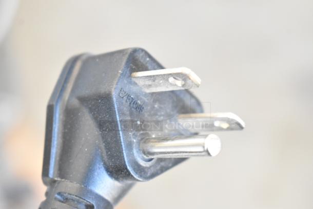 Close-up of a black plug with three prongs, compatible with Avantco MX40H commercial dough mixer, 240V, 1 phase.