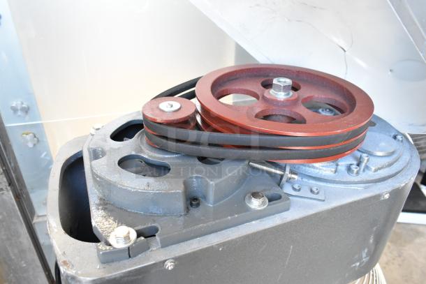Avantco MX40H mixer motor and belt assembly, showing metal parts and red pulleys, in used condition.