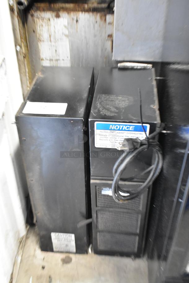 2 Ice Qube IQ1800VS air conditioners, vertical slimline, 120V, 1 phase, black casing, warning labels visible.