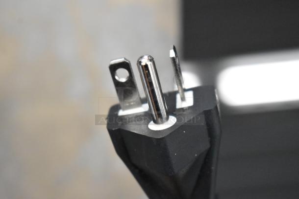Close-up of a three-prong plug from the Avantco 177ID18DB Double Induction Cooker, indicating 208-240V compatibility.