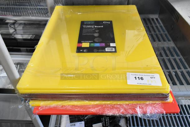 Stack of seven new scratch and dent cutting boards, including Choice yellow polyethylene 24"x18"x1/2" board.