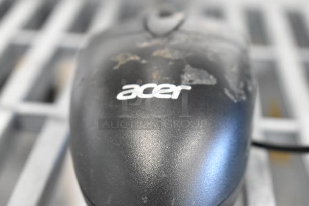 Black Acer computer mouse with visible wear, part of a lot including Ingenico iSC Touch 250 credit card reader.